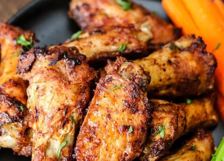 Crispy air fryer chicken wings ready to serve with dipping sauces.