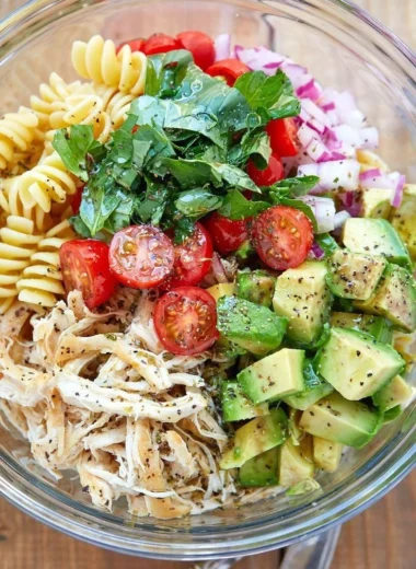 Healthy chicken pasta salad with fresh vegetables and dressing