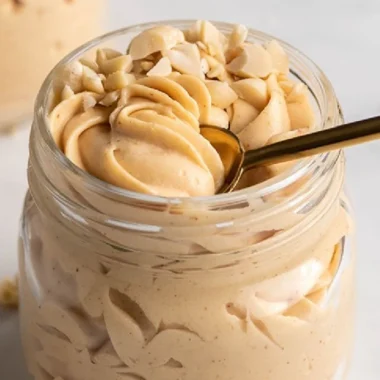 Delicious Keto Peanut Butter Mousse served in a bowl, topped with whipped cream.