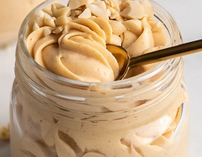 Delicious Keto Peanut Butter Mousse served in a bowl, topped with whipped cream.