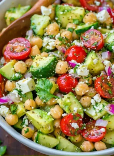 Colorful chickpea salad with vegetables and herbs in a bowl