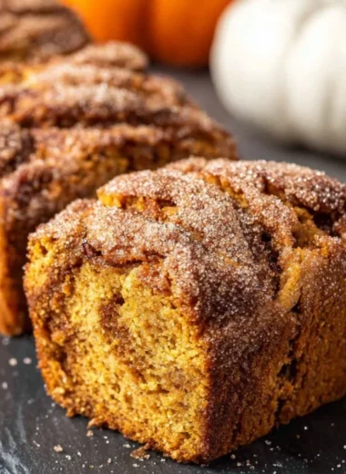 Freshly baked Cinnamon Swirl Pumpkin Bread Minis on a rustic table.