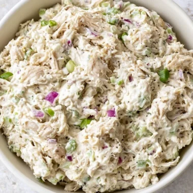 Bowl of easy chicken salad with fresh vegetables and dressing