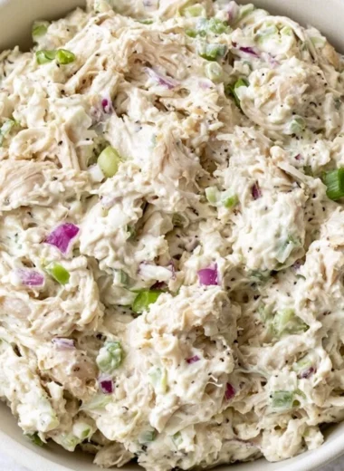 Bowl of easy chicken salad with fresh vegetables and dressing