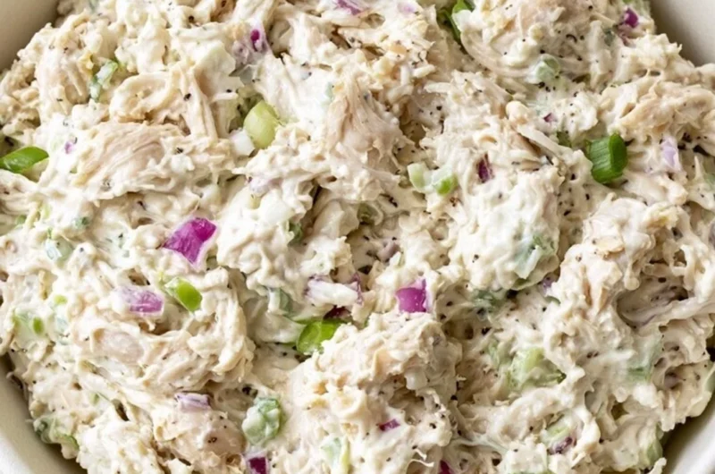 Bowl of easy chicken salad with fresh vegetables and dressing