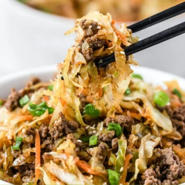 Delicious egg roll in a bowl with fresh vegetables and savory sauce