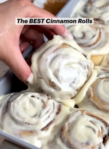 Freshly baked homemade cinnamon rolls topped with icing.