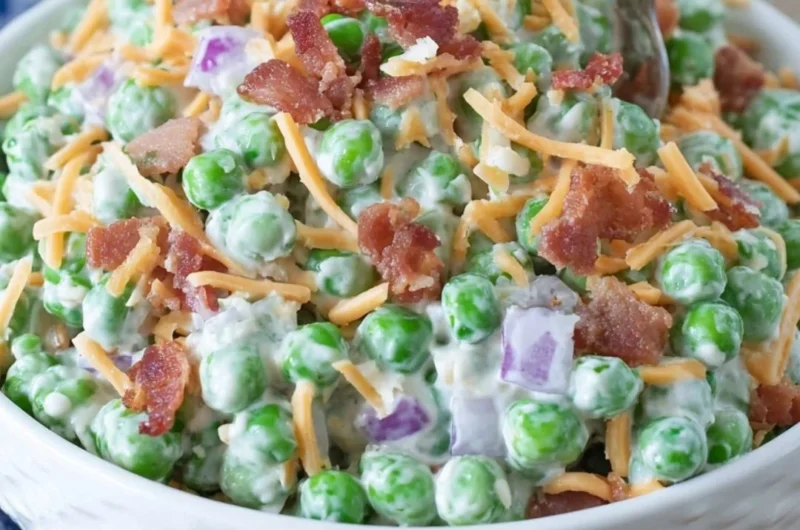 Delicious Old Fashioned Pea Salad served in a bowl, garnished with herbs.
