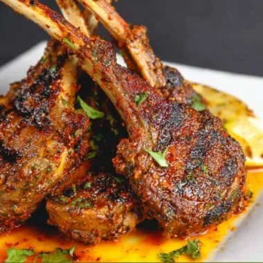 Oven-baked lamb chops served with garnish on a plate