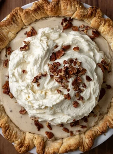 Slice of homemade Pecan Cream Pie with pecans on top