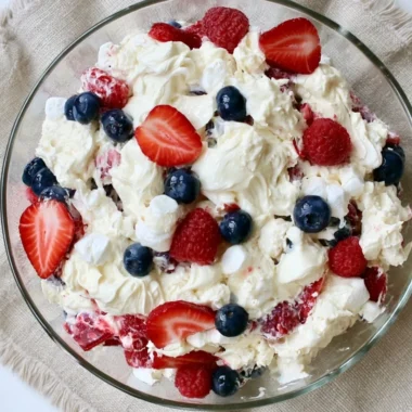 Red White and Blue Cheesecake Salad featuring strawberries, blueberries, and cream cheese.
