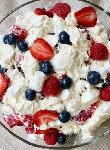 Red White and Blue Cheesecake Salad featuring strawberries, blueberries, and cream cheese.