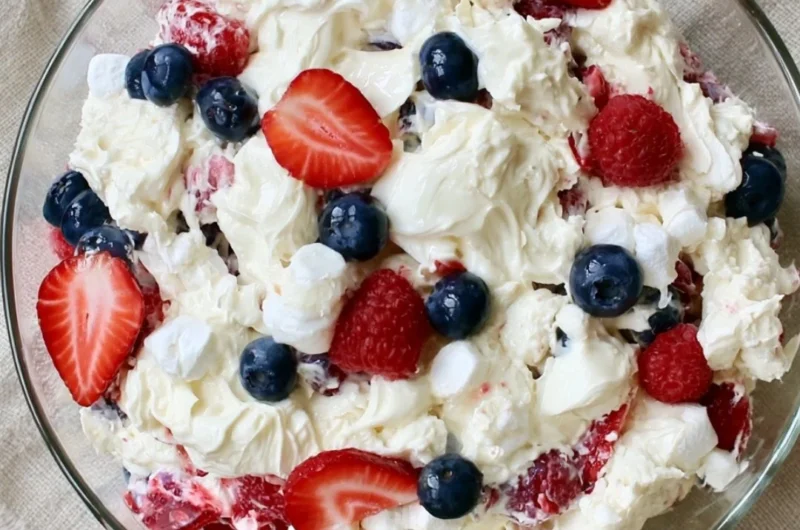 Red White and Blue Cheesecake Salad featuring strawberries, blueberries, and cream cheese.