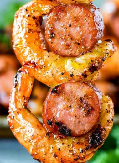 Grilled sausage & shrimp kabobs on skewers, garnished with vegetables.