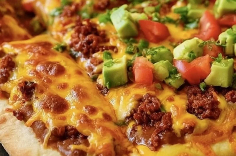 Delicious Taco Pizza topped with beef, veggies, and cheese