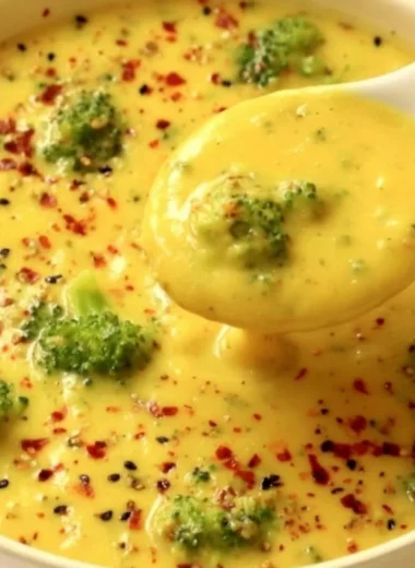 Vegan broccoli potato soup in a bowl garnished with fresh herbs.