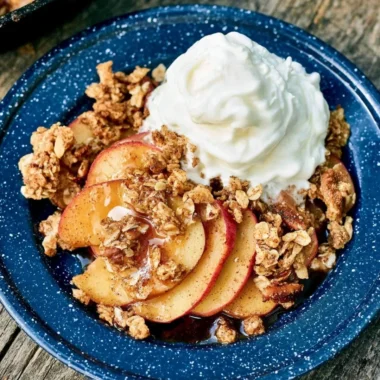 Vegan Campfire Apple Crisp with fresh apples and crispy topping over a campfire
