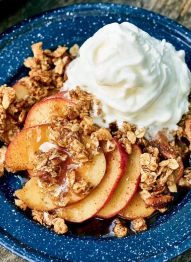 Vegan Campfire Apple Crisp with fresh apples and crispy topping over a campfire