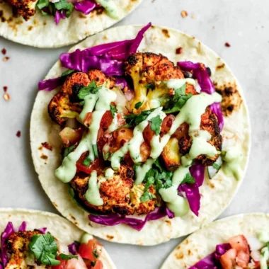 Vegan roasted cauliflower tacos served with fresh toppings