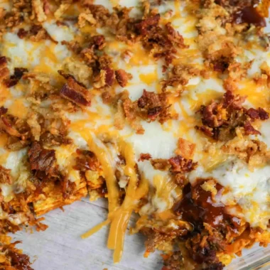 BBQ Bacon Cheeseburger Frito Pie served in a colorful dish with toppings.