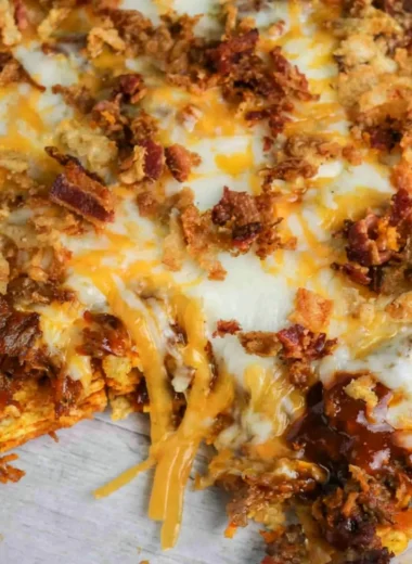 BBQ Bacon Cheeseburger Frito Pie served in a colorful dish with toppings.