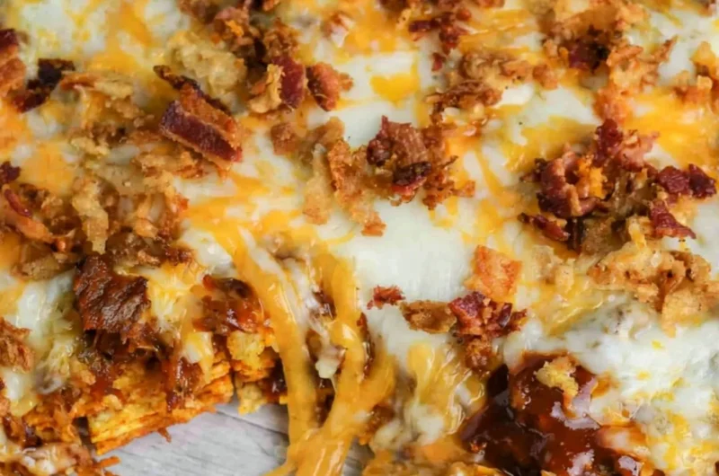 BBQ Bacon Cheeseburger Frito Pie served in a colorful dish with toppings.