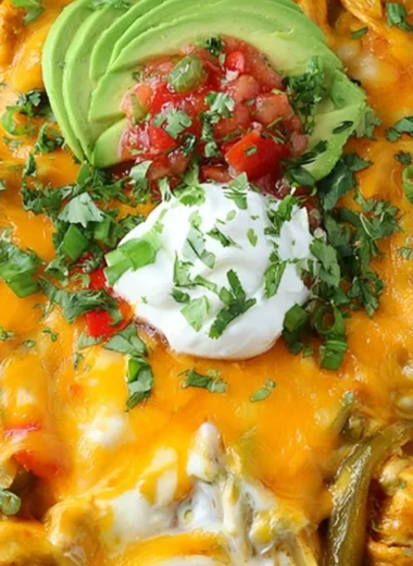 Cheesy chicken fajitas casserole topped with melted cheese and colorful peppers.