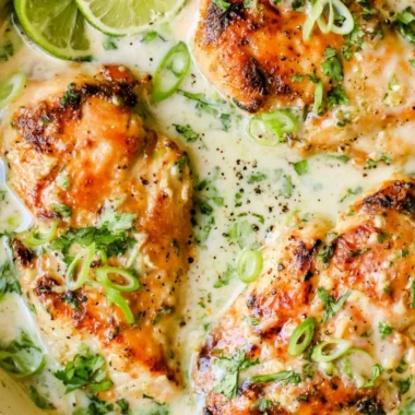 Delicious Coconut Lime Chicken garnished with lime slices and fresh herbs