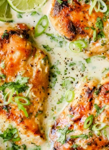 Delicious Coconut Lime Chicken garnished with lime slices and fresh herbs