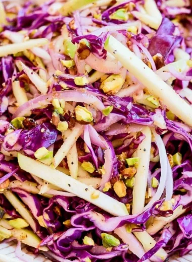 Bowl of cozy cabbage apple slaw with vibrant green cabbage and crisp apple slices
