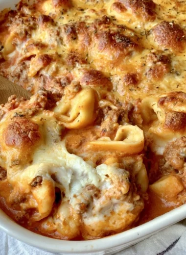 Cozy cheesy baked tortellini casserole served in a rustic dish