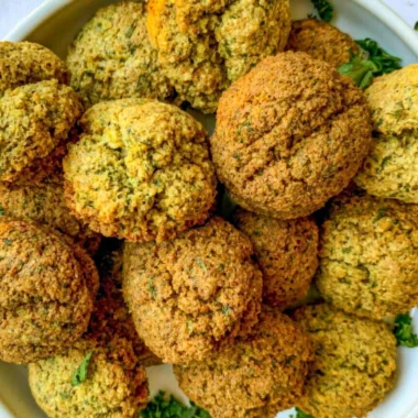 Plate of cozy homemade falafel with fresh vegetables and dipping sauce