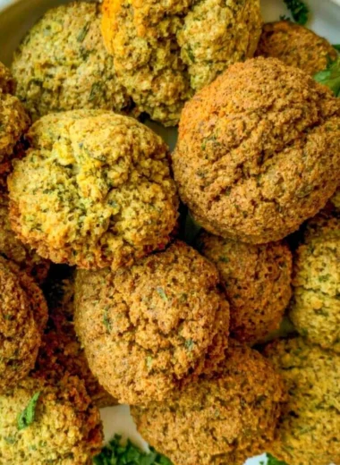 Plate of cozy homemade falafel with fresh vegetables and dipping sauce