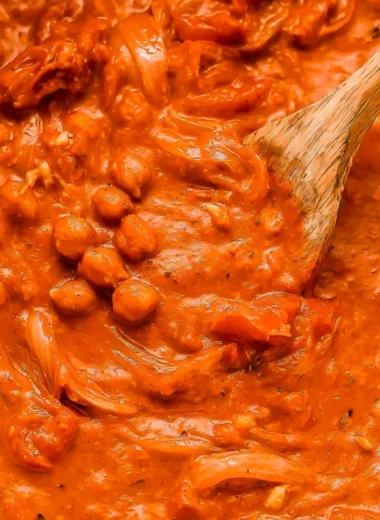 Creamy coconut chickpea curry served in a bowl with fresh herbs garnish