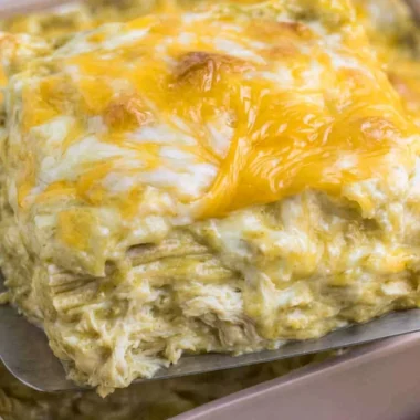 Delicious green chili chicken enchiladas topped with cheese and fresh herbs