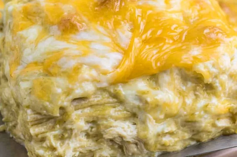 Delicious green chili chicken enchiladas topped with cheese and fresh herbs