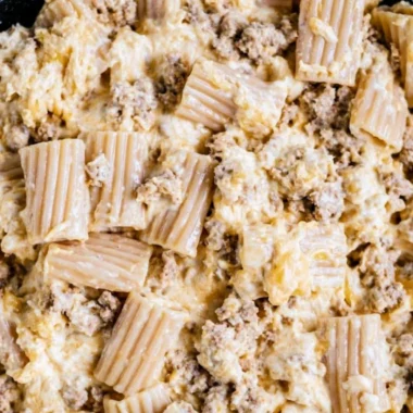 A creamy bowl of homemade cheeseburger pasta topped with cheese and herbs.