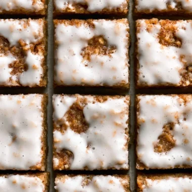 Delicious iced oatmeal cookie bars topped with a creamy glaze.