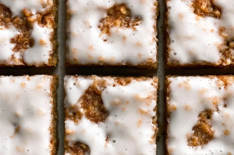 Delicious iced oatmeal cookie bars topped with a creamy glaze.