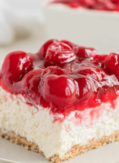 No bake cherry cheesecake topped with fresh cherries and whipped cream