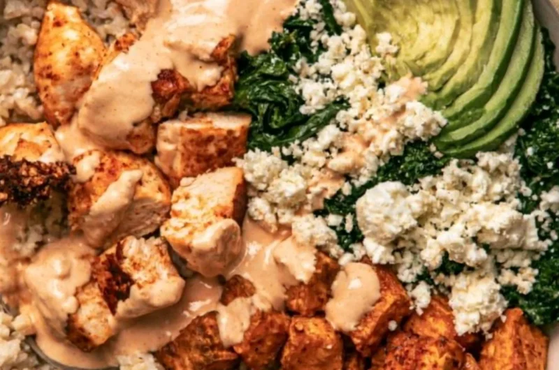 Roasted chicken served over sweet potato rice in a colorful bowl