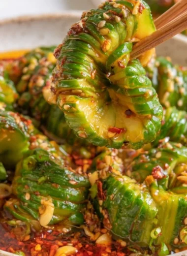 Bowl of spicy Asian cucumber salad with vibrant vegetables and herbs