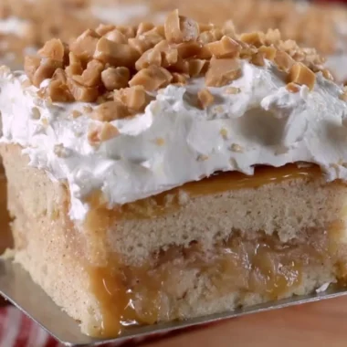 Delicious Caramel Apple Poke Cake with caramel drizzle and apple slices