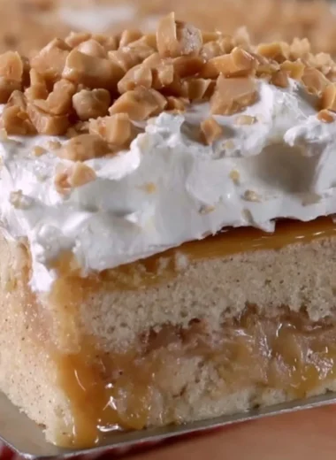 Delicious Caramel Apple Poke Cake with caramel drizzle and apple slices