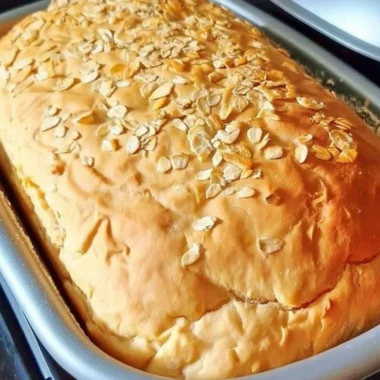 Freshly baked cozy honey oat bread with a golden crust and soft texture