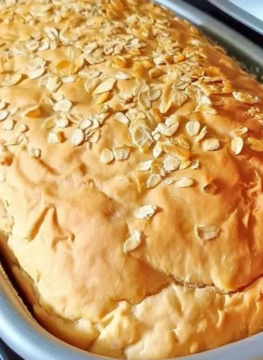 Freshly baked cozy honey oat bread with a golden crust and soft texture